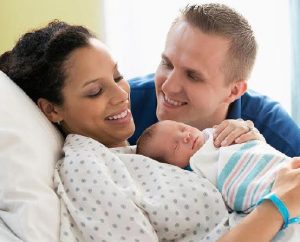 Parents holding a new born baby
