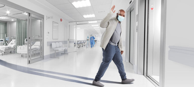 man with mask walking out door